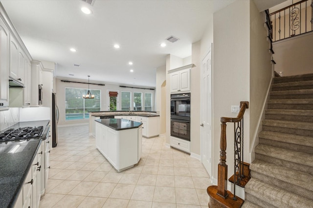 15411 Driftwood Oak Ct, Houston, TX 77059 - kitchen with stainless steel appliances, dark countertops, a kitchen island, recessed lighting, and decorative light fixtures