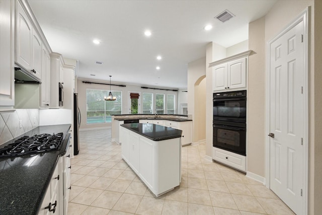 15411 Driftwood Oak Ct, Houston, TX 77059 - kitchen featuring stainless steel appliances, a peninsula, backsplash, recessed lighting, and light tile patterned floors