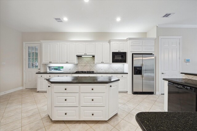 15411 Driftwood Oak Ct, Houston, TX 77059 - kitchen with black appliances, dark countertops, tasteful backsplash, white cabinets, and light tile patterned floors