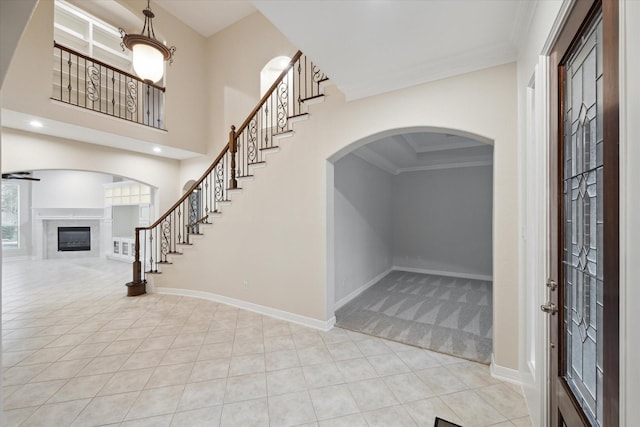 15411 Driftwood Oak Ct, Houston, TX 77059 - entryway with a high end fireplace, tile patterned flooring, ornamental molding, carpet, and stairs