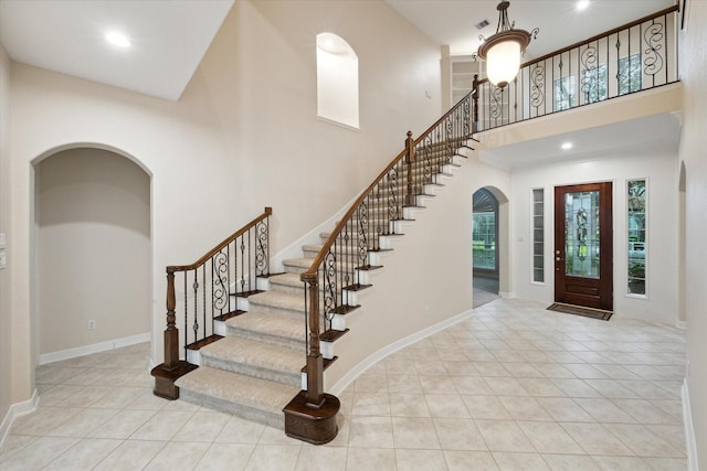 15411 Driftwood Oak Ct, Houston, TX 77059 - tiled entrance foyer with arched walkways, a towering ceiling, stairway, and recessed lighting