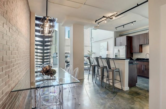 2000 Bagby St Unit 9420, Houston, TX 77002 - dining space featuring brick wall and concrete flooring