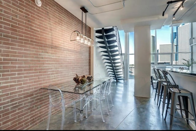 2000 Bagby St Unit 9420, Houston, TX 77002 - unfurnished dining area with concrete floors, brick wall, and floor to ceiling windows
