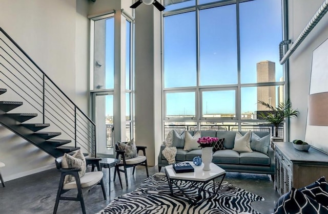 2000 Bagby St Unit 9420, Houston, TX 77002 - living room with a towering ceiling, stairway, ceiling fan, and concrete floors