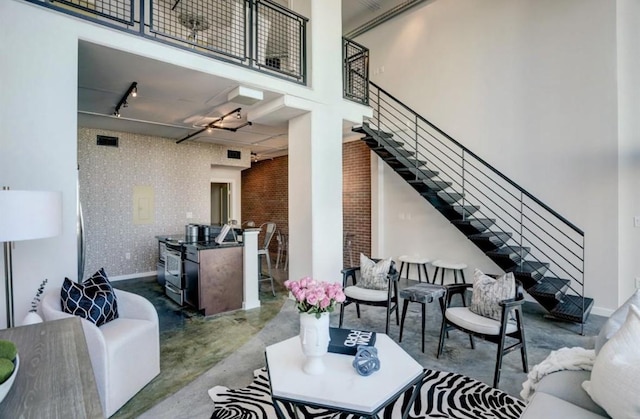 2000 Bagby St Unit 9420, Houston, TX 77002 - living area with finished concrete floors, stairs, track lighting, and a towering ceiling