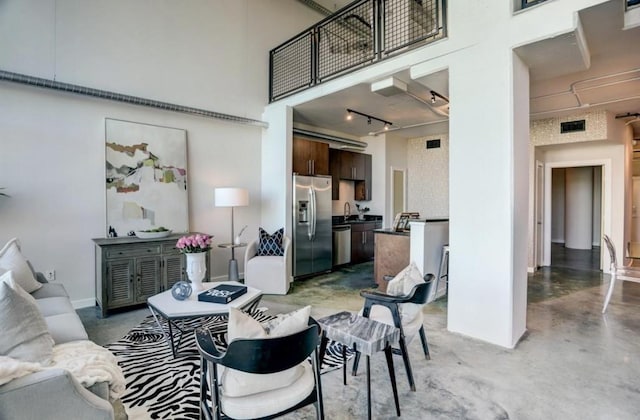 2000 Bagby St Unit 9420, Houston, TX 77002 - living area featuring finished concrete floors, a towering ceiling, and track lighting