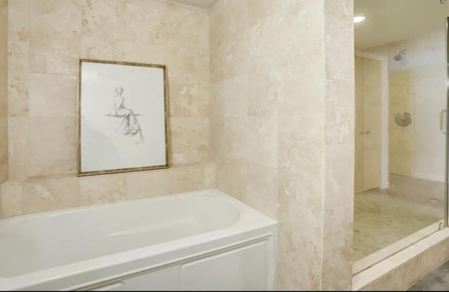 2000 Bagby St Unit 9420, Houston, TX 77002 - full bathroom with a bath, a stall shower, and tile walls
