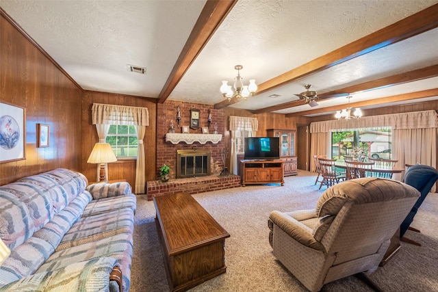 91 E Post Oak Ln, Shepherd, TX 77371 - living room featuring a chandelier, wooden walls, light colored carpet, a textured ceiling, and a fireplace