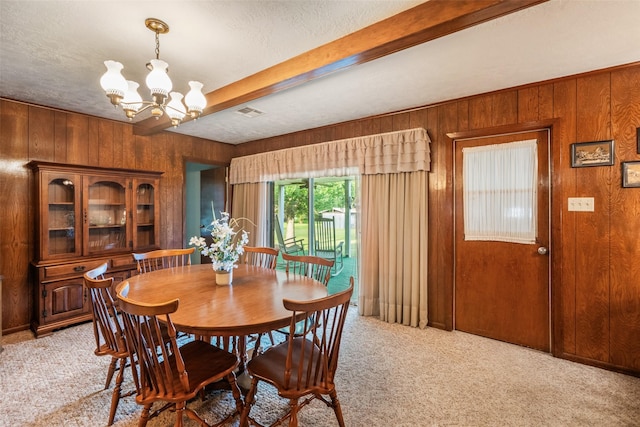 91 E Post Oak Ln, Shepherd, TX 77371 - dining area featuring wooden walls, light carpet, beam ceiling, a chandelier, and a textured ceiling
