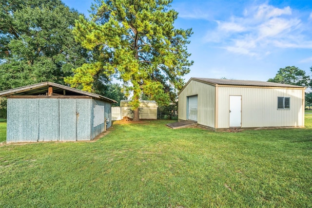 91 E Post Oak Ln, Shepherd, TX 77371 - view of grassy yard featuring a garage and an outdoor structure