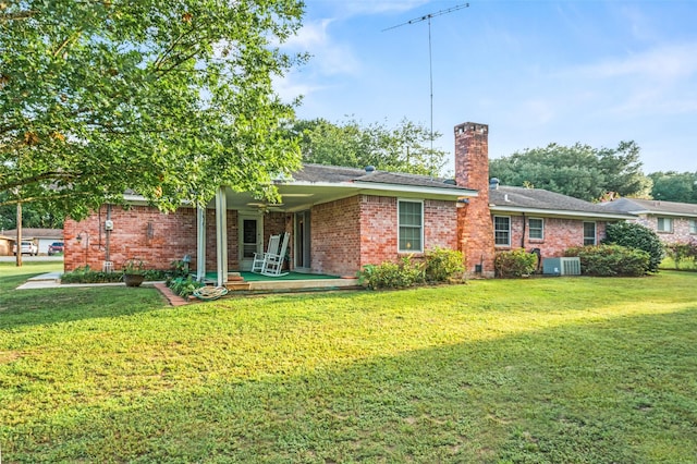 91 E Post Oak Ln, Shepherd, TX 77371 - rear view of property with a chimney, a lawn, brick siding, and a shingled roof