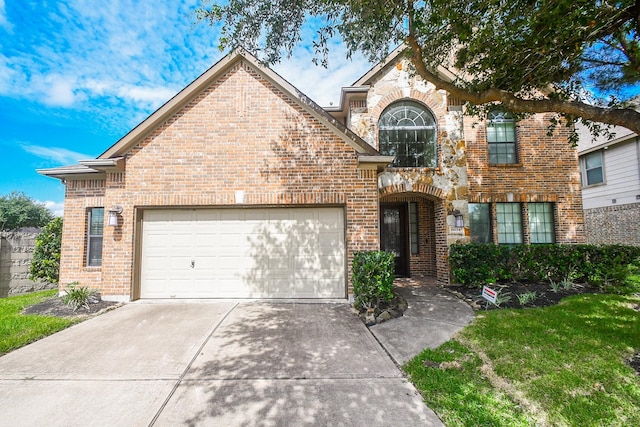 6034 Gracys Landing Ln, Katy, TX 77494 - traditional home featuring brick siding, an attached garage, driveway, and a front yard