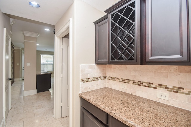 6034 Gracys Landing Ln, Katy, TX 77494 - kitchen featuring tasteful backsplash, light stone counters, dark brown cabinetry, and recessed lighting