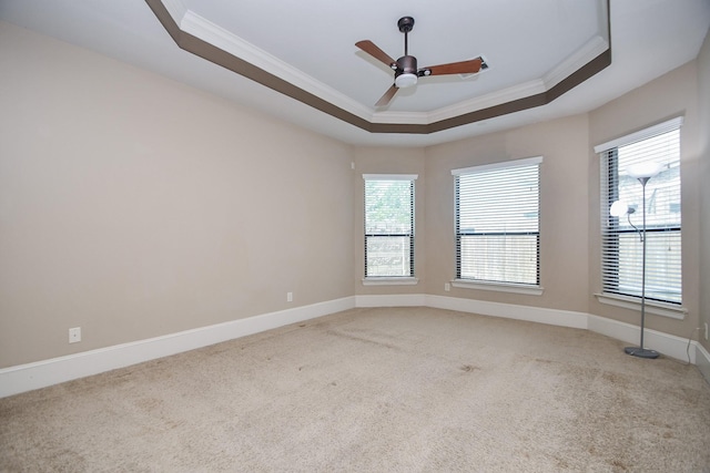 6034 Gracys Landing Ln, Katy, TX 77494 - empty room with ornamental molding, a tray ceiling, carpet floors, a ceiling fan, and healthy amount of natural light
