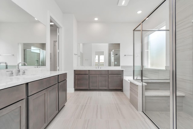 21118 Chelton Beach Dr, Cypress, TX 77433 - bathroom with two vanities, a shower stall, plenty of natural light, and recessed lighting