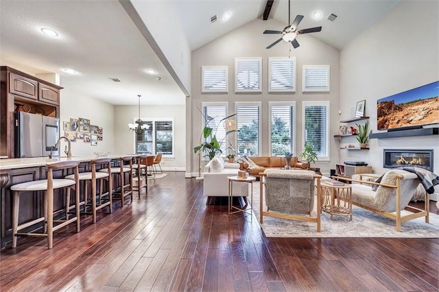 10210 Grape Creek Grove Ln, Cypress, TX 77433 - living room with high vaulted ceiling, ceiling fan, dark wood finished floors, beam ceiling, and a glass covered fireplace