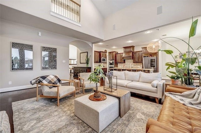10210 Grape Creek Grove Ln, Cypress, TX 77433 - living room featuring wood finished floors, arched walkways, plenty of natural light, recessed lighting, and a towering ceiling