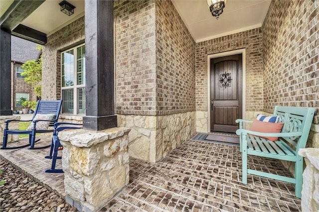 10210 Grape Creek Grove Ln, Cypress, TX 77433 - view of exterior entry featuring brick siding, covered porch, and stone siding