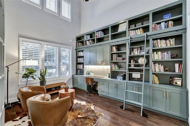 10210 Grape Creek Grove Ln, Cypress, TX 77433 - home office featuring built in study area, healthy amount of natural light, dark wood-style floors, and a towering ceiling