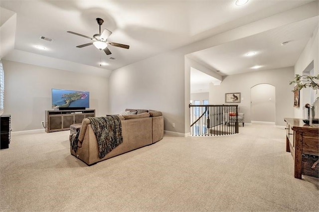 10210 Grape Creek Grove Ln, Cypress, TX 77433 - living room featuring arched walkways, light carpet, ceiling fan, and recessed lighting