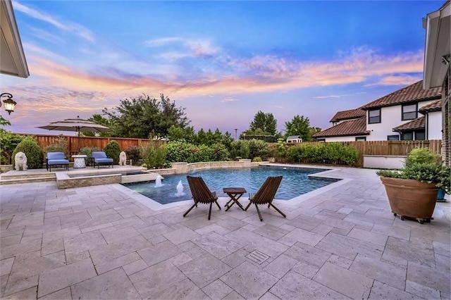 10210 Grape Creek Grove Ln, Cypress, TX 77433 - pool at dusk featuring a patio area and a pool with connected hot tub