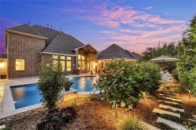 10210 Grape Creek Grove Ln, Cypress, TX 77433 - pool at dusk with a patio area and an outdoor pool