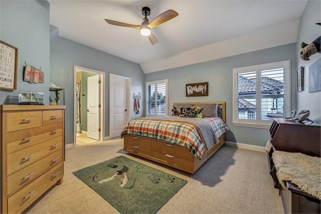 10210 Grape Creek Grove Ln, Cypress, TX 77433 - bedroom featuring light carpet, multiple windows, vaulted ceiling, a ceiling fan, and ensuite bath