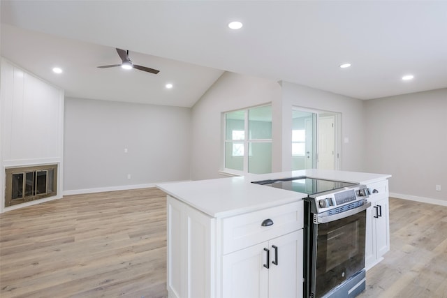 10260 Field Stone Dr, Houston, TX 77041 - kitchen with stainless steel range with electric cooktop, a ceiling fan, light wood finished floors, white cabinets, and recessed lighting