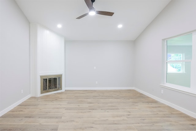10260 Field Stone Dr, Houston, TX 77041 - unfurnished living room with ceiling fan, recessed lighting, light wood-style flooring, a glass covered fireplace, and vaulted ceiling