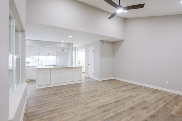 10260 Field Stone Dr, Houston, TX 77041 - unfurnished living room with light wood-style floors, ceiling fan, recessed lighting, and a high ceiling