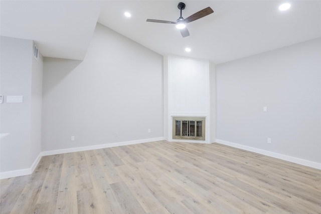 10260 Field Stone Dr, Houston, TX 77041 - unfurnished living room featuring a ceiling fan, recessed lighting, light wood-style floors, lofted ceiling, and a glass covered fireplace