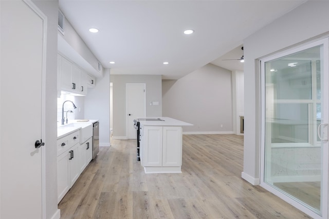 10260 Field Stone Dr, Houston, TX 77041 - kitchen featuring white cabinetry, light countertops, light wood-style flooring, dishwasher, and recessed lighting