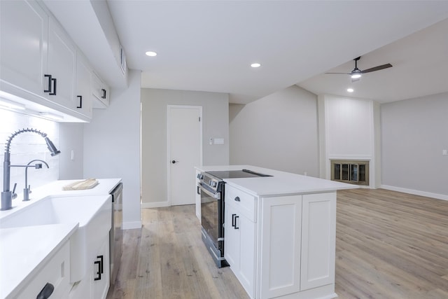 10260 Field Stone Dr, Houston, TX 77041 - kitchen with electric range oven, light wood-style flooring, a ceiling fan, white cabinets, and recessed lighting