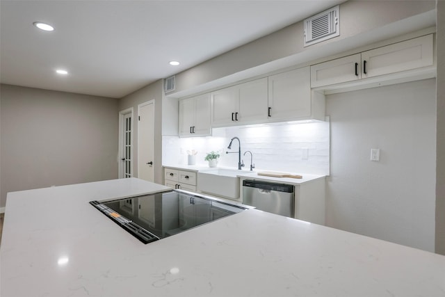 10260 Field Stone Dr, Houston, TX 77041 - kitchen with stainless steel dishwasher, white cabinetry, recessed lighting, and tasteful backsplash