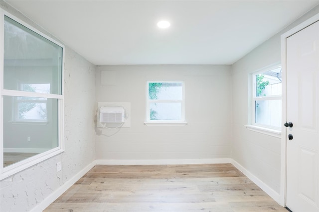 10260 Field Stone Dr, Houston, TX 77041 - unfurnished room featuring a wall mounted air conditioner and light wood-type flooring