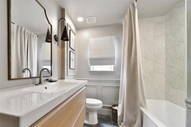5503 Cheshire Ln, Houston, TX 77092 - full bathroom featuring vanity, a decorative wall, shower / tub combo with curtain, tile patterned flooring, and a wainscoted wall