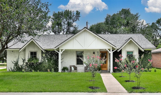5503 Cheshire Ln, Houston, TX 77092 - view of front facade featuring a shingled roof, a front lawn, and brick siding