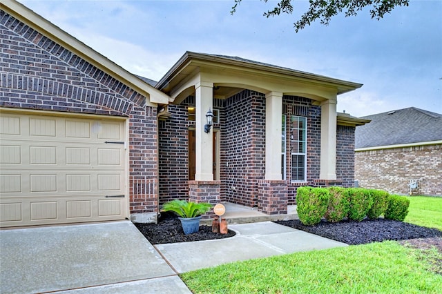 5311 Persimmon Pass, Richmond, TX 77407 - view of exterior entry with brick siding, a garage, and concrete driveway