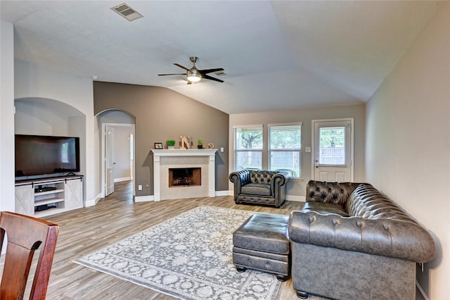5311 Persimmon Pass, Richmond, TX 77407 - living area featuring ceiling fan, wood finished floors, vaulted ceiling, and a tile fireplace