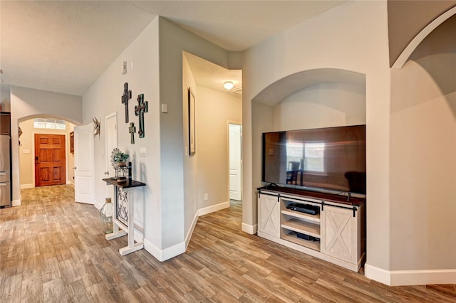 5311 Persimmon Pass, Richmond, TX 77407 - hallway with light wood-style flooring and arched walkways