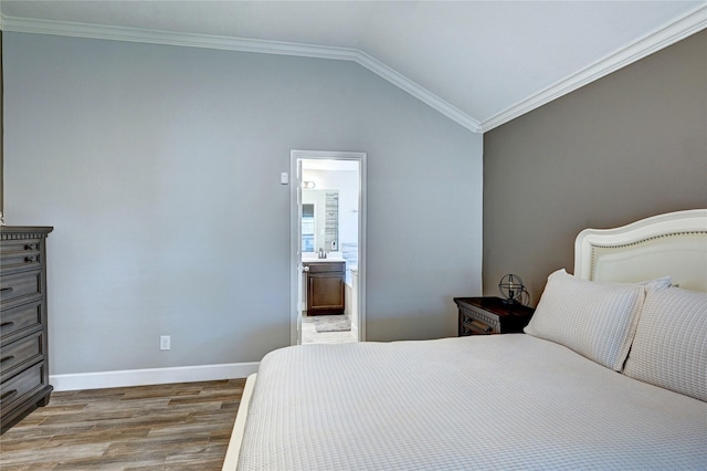 5311 Persimmon Pass, Richmond, TX 77407 - bedroom with wood finished floors, lofted ceiling, ensuite bath, and ornamental molding