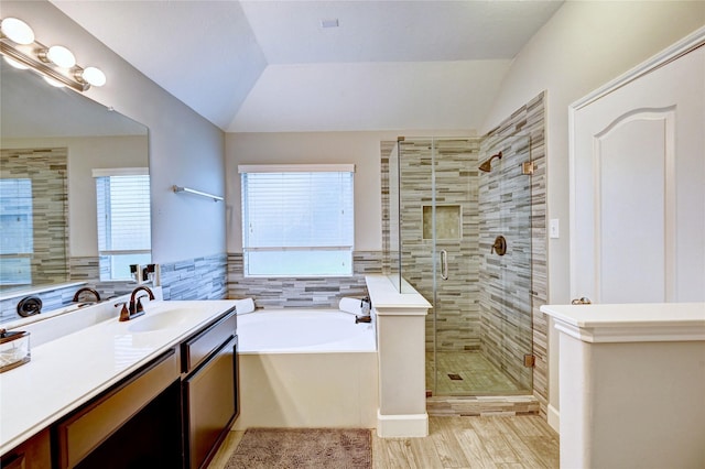 5311 Persimmon Pass, Richmond, TX 77407 - full bathroom with a garden tub, vanity, a stall shower, lofted ceiling, and wood finished floors