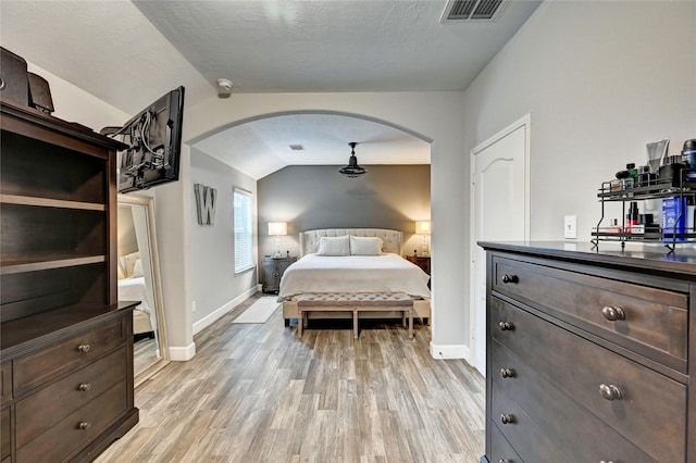 5311 Persimmon Pass, Richmond, TX 77407 - bedroom with arched walkways, vaulted ceiling, and light wood-style flooring