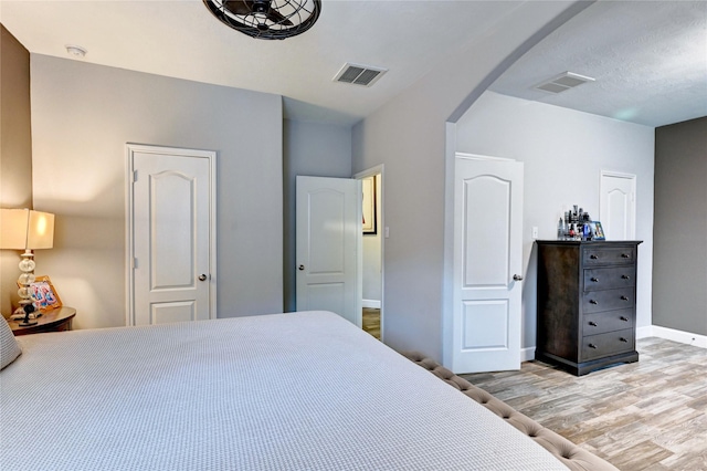 5311 Persimmon Pass, Richmond, TX 77407 - bedroom with wood finished floors and arched walkways