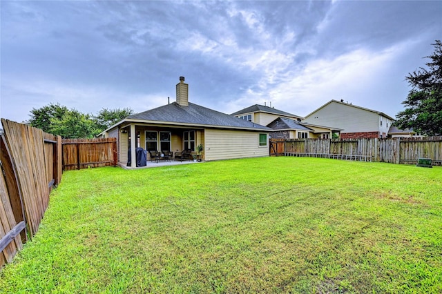 5311 Persimmon Pass, Richmond, TX 77407 - back of house with a chimney, a fenced backyard, and a patio area