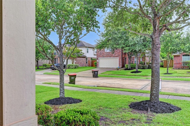 5311 Persimmon Pass, Richmond, TX 77407 - view of green lawn featuring concrete driveway and a garage