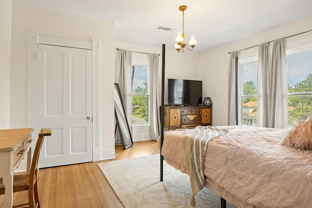501 Branch St, Taylor, TX 76574 - bedroom featuring multiple windows, a chandelier, and light wood-style flooring