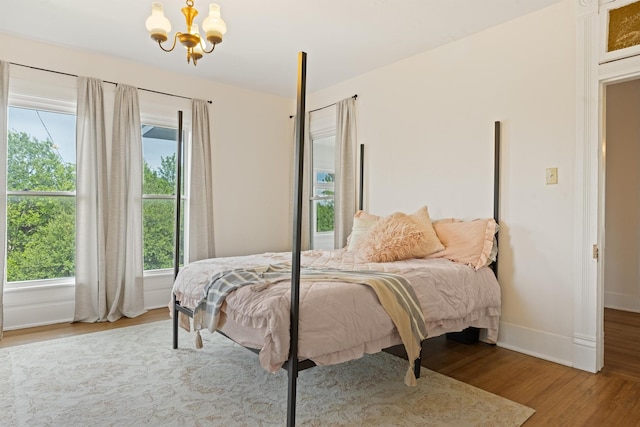 501 Branch St, Taylor, TX 76574 - bedroom featuring a chandelier and wood finished floors