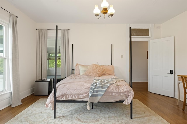 501 Branch St, Taylor, TX 76574 - bedroom with wood finished floors and a chandelier