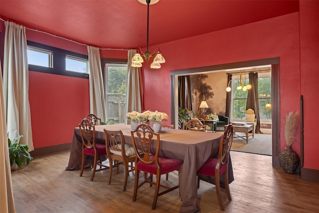 501 Branch St, Taylor, TX 76574 - dining space featuring a chandelier, wood finished floors, and healthy amount of natural light